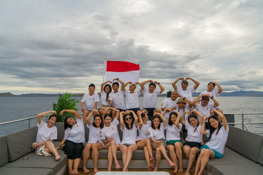 Group photo with flag on deck